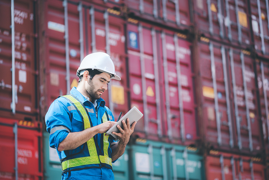 Man standing in front of shipping containers