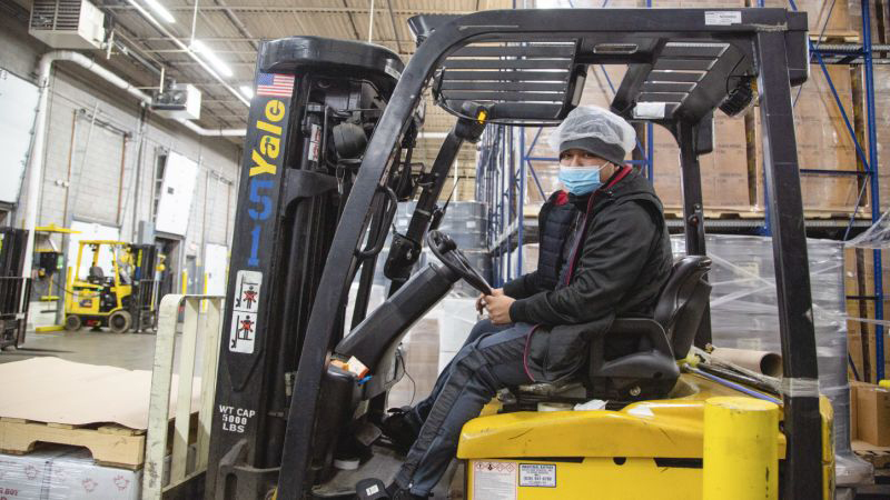 Columbus Vegetable Oil worker on a machine inside one of their factories