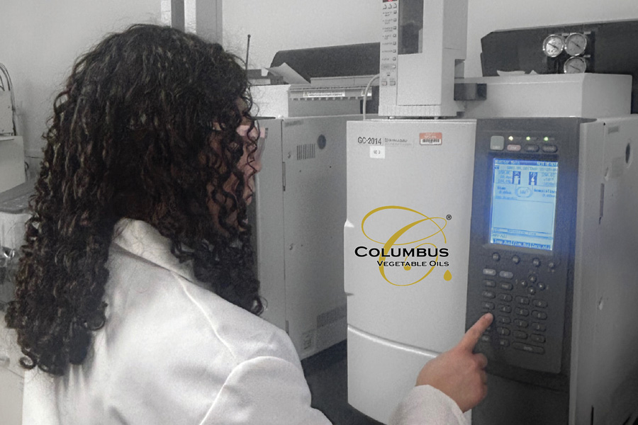 Columbus vegetable oil employee using a piece of Columbus Vegetable Oil branded equipment inside a lab