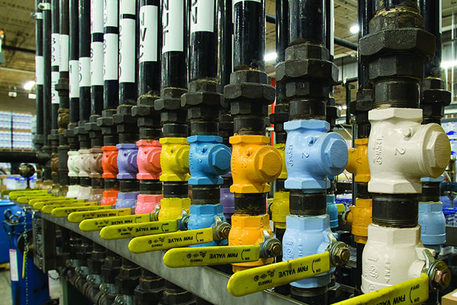 Tubs transferring oil of different colors inside a factory