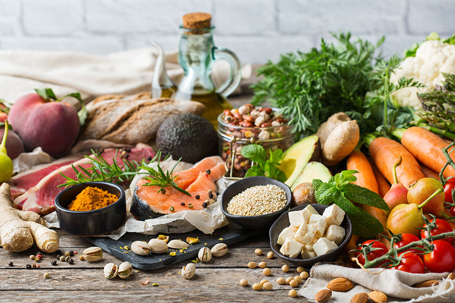 An array of ingredients used in vegetable oil sitting on a wooden table